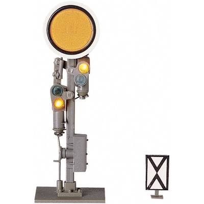 Model of a railway signal with an illuminated yellow main signal and two small light signals. Signal board with a cross underneath.