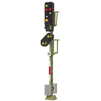 Railway signal with multiple lights: Red and green at the top, yellow and green at the bottom, both positioned diagonally.