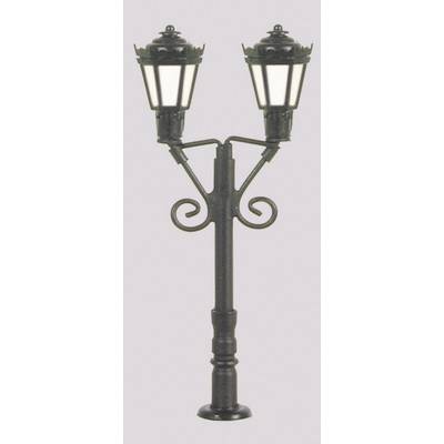 A black street lamp with two lights in an antique style stands against a light grey background.