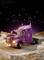 Lila's lorry stands on a gravel road in a rocky landscape beneath a starry sky. The lights are switched on.