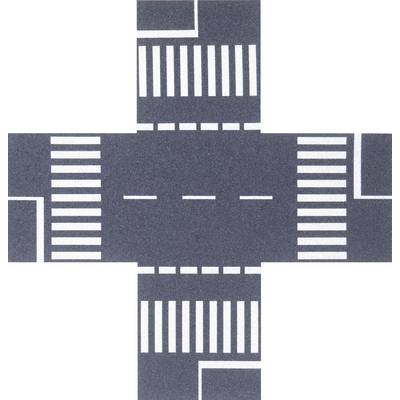 An aerial view of a crossroads with zebra crossings on all four sides in an urban setting.