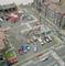City model with fire brigade exercise: Numerous miniature figures, fire engines and spectators in front of town buildings. Junction and car parks visible.