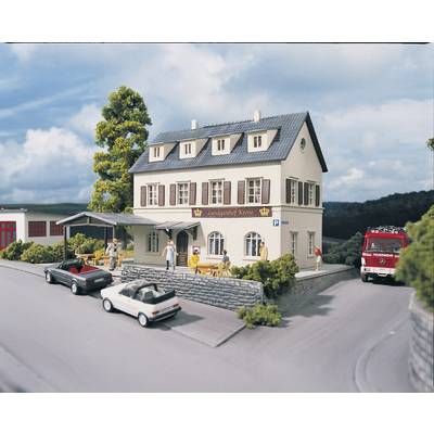 Miniature model of a two-storey inn named 'Landgasthof Krone' on a street corner with parked cars and a fire engine.