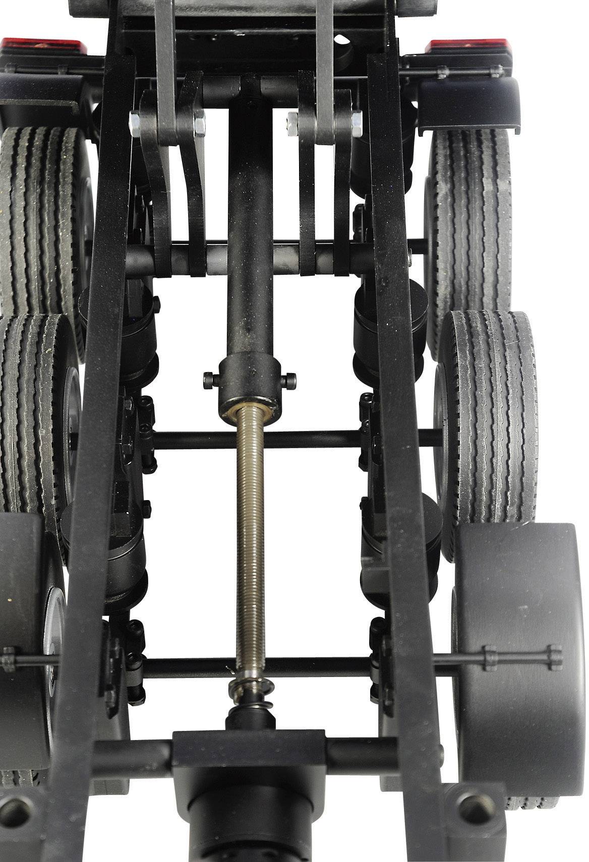 Close-up of a lorry chassis with multiple axles and tyres. View of the suspension system and shock absorbers.