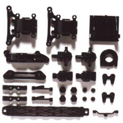 Several black plastic parts arranged in two rows, presumably components for a model car or technical assembly.
