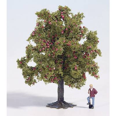 A miniature figurine leans against a model apple tree with many red apples.