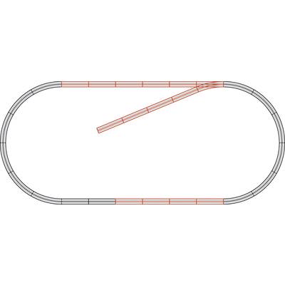 'Simple model railway track in an oval shape with a branching red rail leading inwards.'