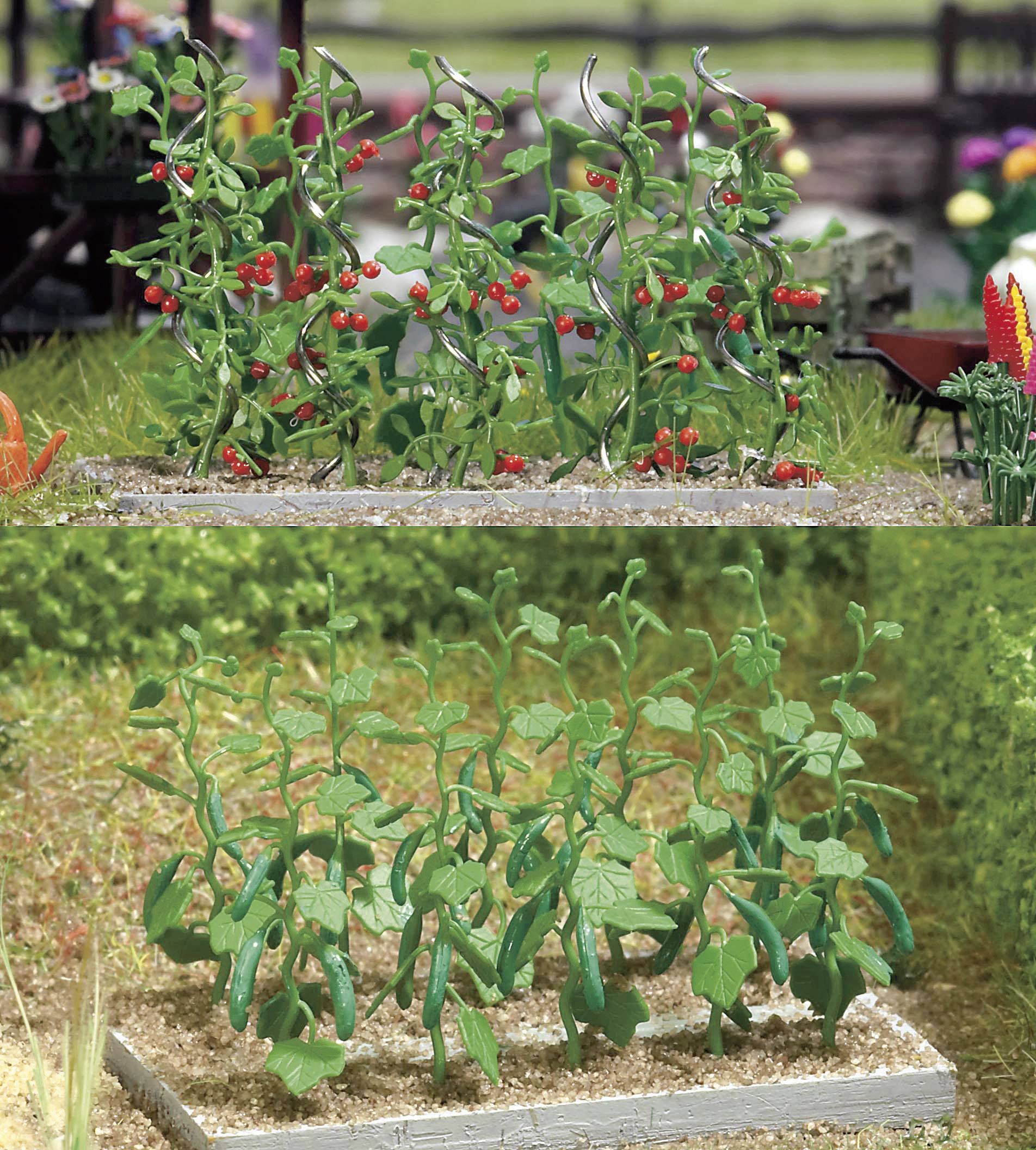 Two planters: The top one with ripe tomatoes on vines, the bottom one with green plants without visible fruits, standing on a grassy area.