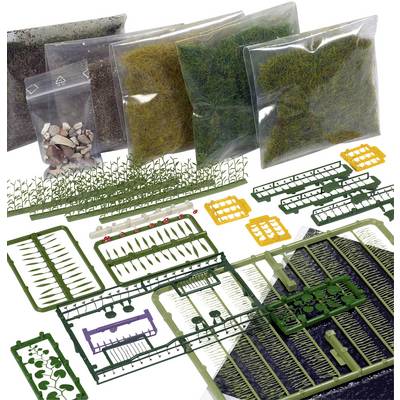 Various bags of model-making materials such as grass scatter, plants, and stones, arranged on a white surface.