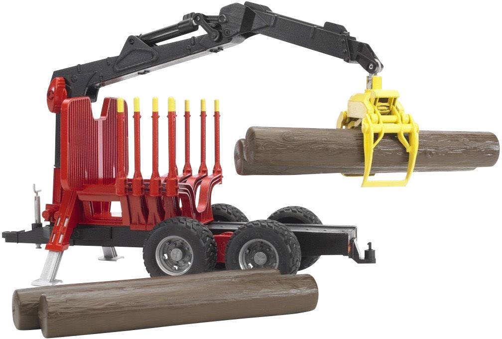 A toy lorry with a crane lifts a wooden log. More logs are lying beside it. The crane is red with a yellow grabber.