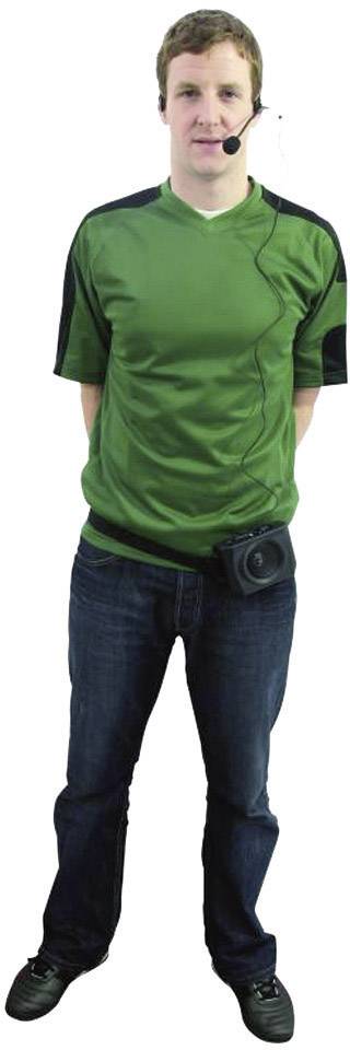 A man wearing a green jersey, with a headset and an attached camera, stands upright and looks ahead.