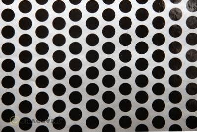Black and white spotted surface, closely clustered black circles on a white background.