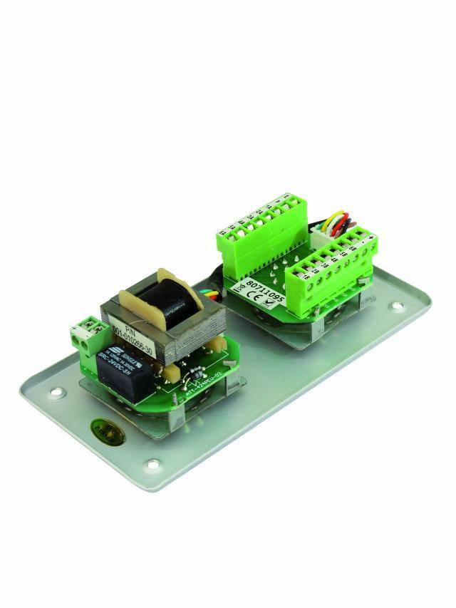 An electronic circuit with green connection terminals mounted on a metal plate, used for connecting electrical components.