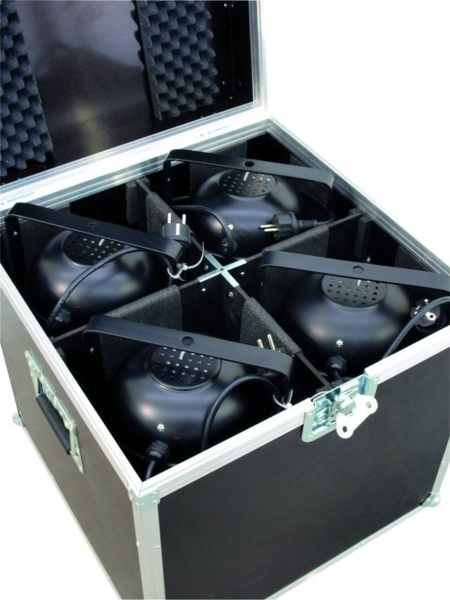 Four black stage lights are arranged in a padded transport case.