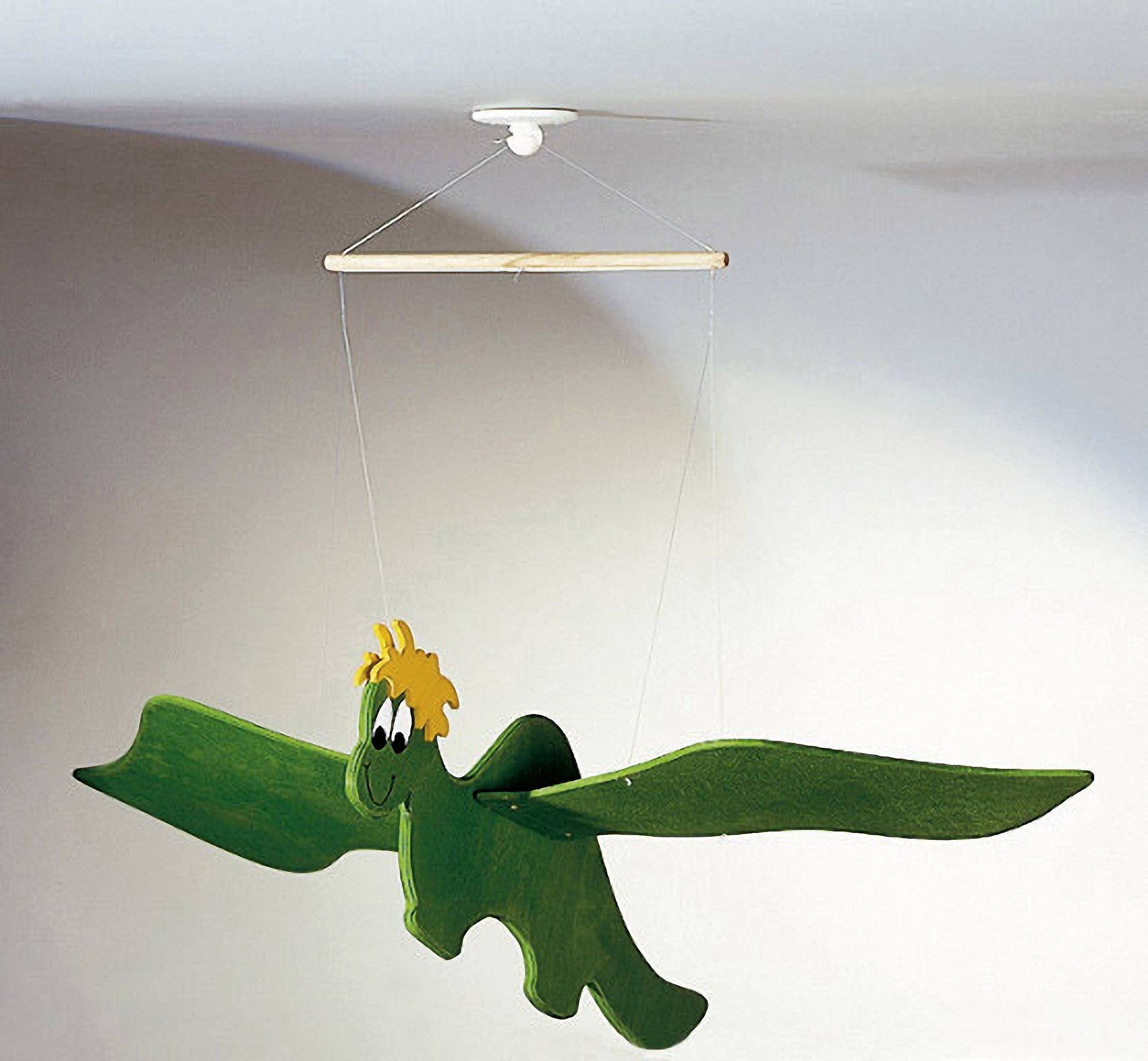 A green wooden dragon with a yellow mane hangs from threads attached to a wooden rod on the ceiling.