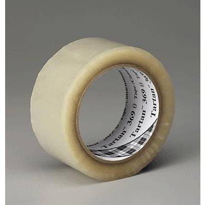 A roll of transparent adhesive tape, partially unrolled, stands upright on a grey surface.