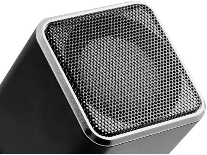 Close-up of a modern, rectangular speaker with a silver border and black grille, slightly angled in its presentation.