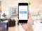 A smartphone scans an NFC-enabled wall switch. The website of 'hugomüller' appears on the screen to modify settings.