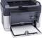 Black and grey office printer with an open paper output tray and a stack of paper loaded. Buttons and lights on the right-hand side.