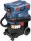 A blue and black Bosch vacuum cleaner with wheels and a red button, suitable for professional cleaning work.