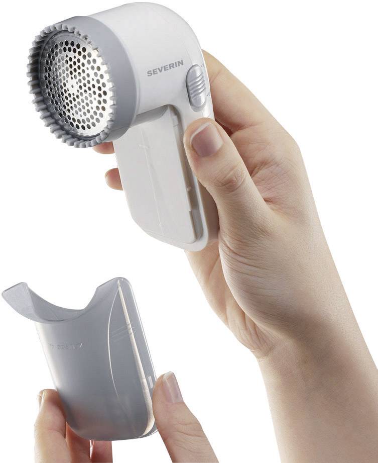 The image shows two hands holding a lint shaver and removing the lower cover.