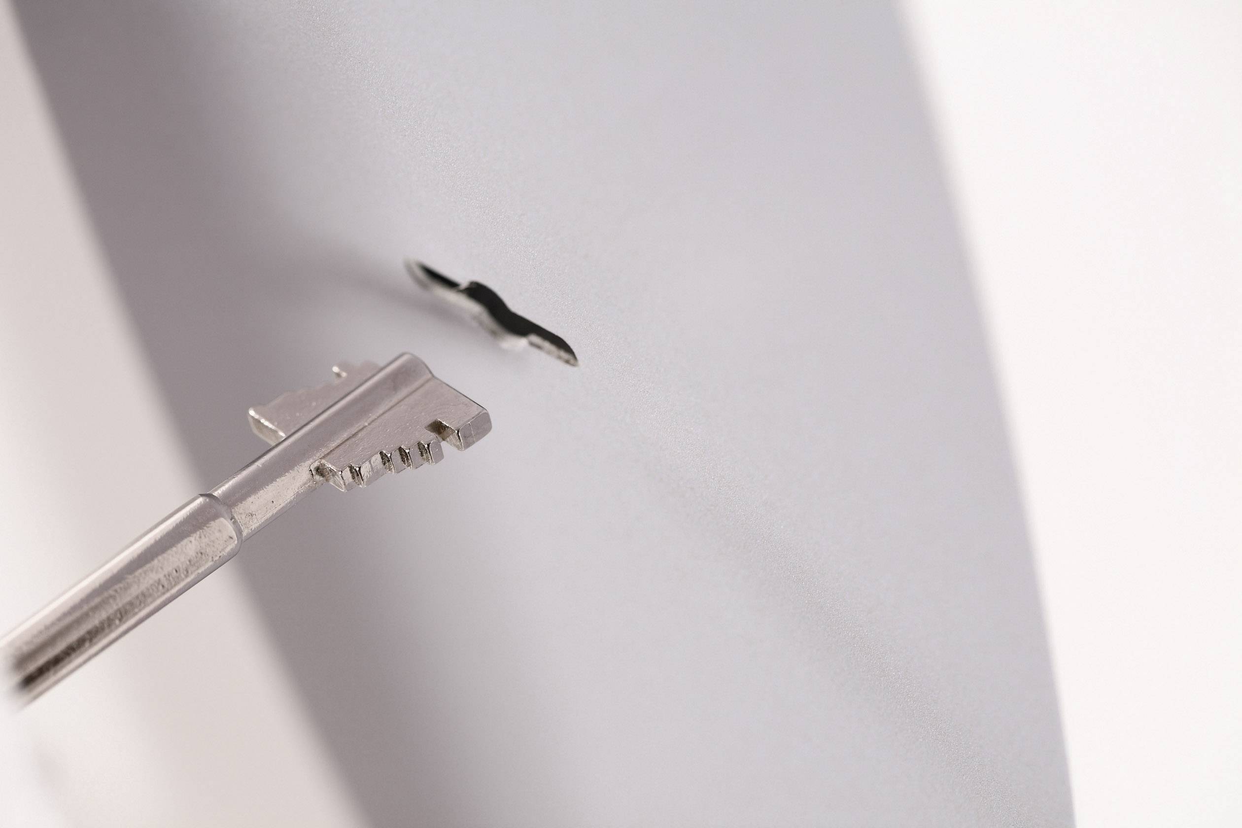 A key is inserted into a lock, close-up. Symbolises security or access.