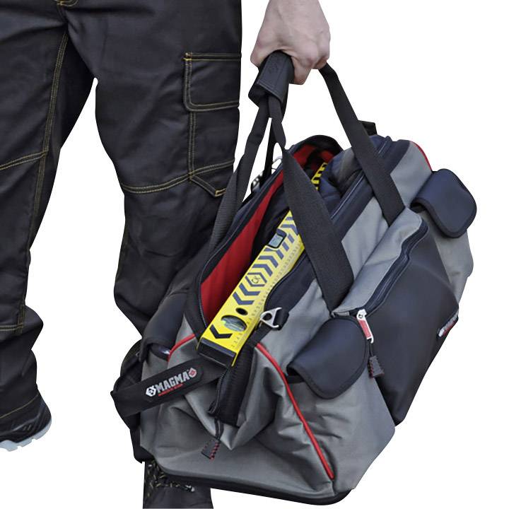A person is carrying a grey tool bag with yellow safety details and multiple compartments.