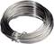 A coil of shiny metal wire in a circular loop, suitable for craft or construction projects.