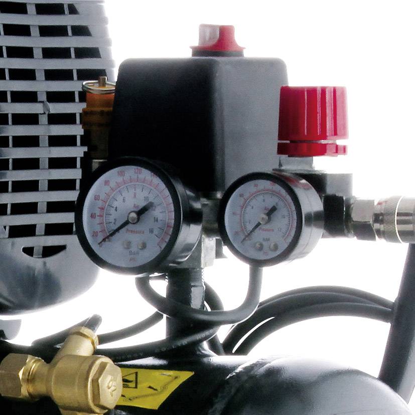 A compressed air compressor with two pressure gauges and several valves indicates the current pressure level.