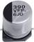 Silver electrolytic capacitor with black marking on top. Inscription: '390 VFP. 6JD'. Electronic component for voltage stabilisation.