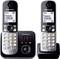Two Panasonic cordless phones with a digital base station, keypad, display showing telephone number. Answerphone displays '28.'