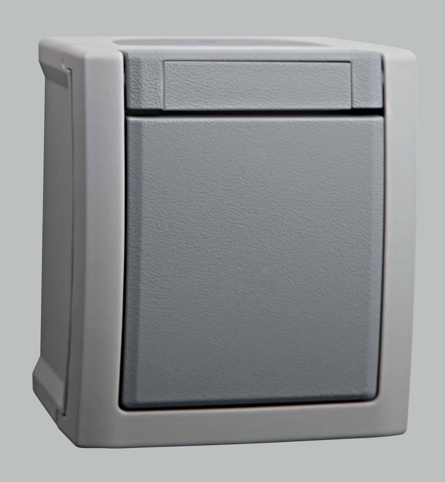 A grey, angular wall switch in a neutral grey shade against a neutral background.