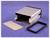 Silver rectangular aluminium housing on a purple background, open with accompanying lid, screws, and black sealing ring.