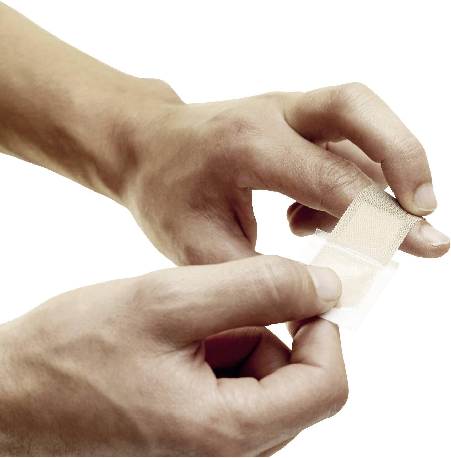 A person opens a plaster, ready to apply to the skin.