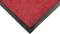 Red doormat with a black border, view of the bottom corner. Suitable for entrance areas, provides non-slip grip.