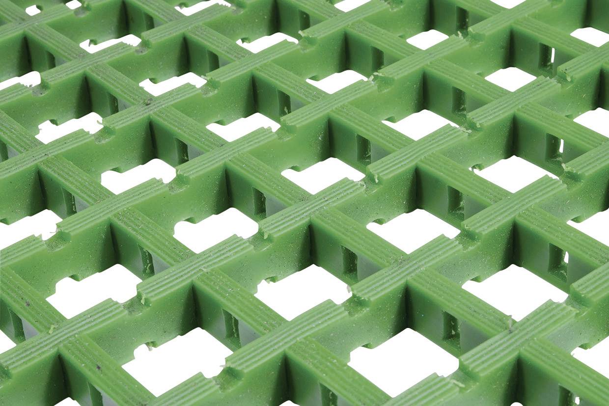 Green plastic grid pattern with square openings, showing a structured surface from a diagonal perspective.
