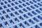 A close-up of a blue grid with uniform square openings in a geometrical pattern.