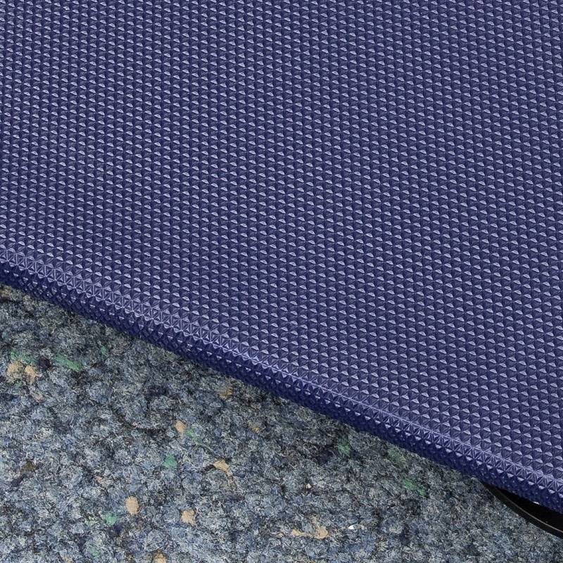 Blue, structured carpet edging on a green-blue floor that appears slightly worn.