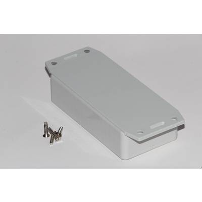 White rectangular plastic box with rounded corners on a white surface. Four small metal screws are lying beside it.
