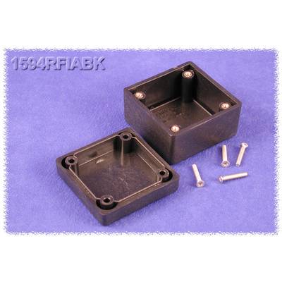 Black, rectangular plastic housing in two parts, opened. Four screws are lying beside it on a blue surface.