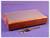 A wooden box with a metal lid, with a calliper lying beside it on a blue background.