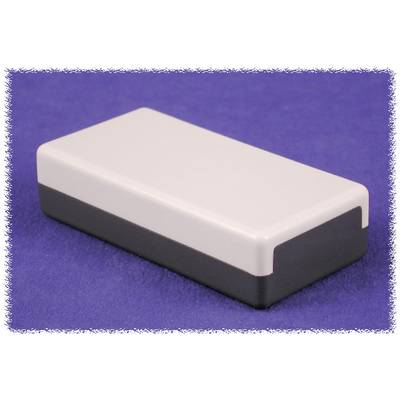 A rectangular, black and white case rests on a purple surface.