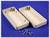 Plastic housing split into two halves, opened against a blue background. Four screws and a bolt are placed in front of it.