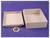 Rectangular grey plastic casing opened on a purple background, with lid beside it and a cable. Accessory ready for assembly.