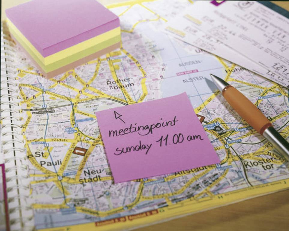 Note on card with text 'meeting point Sunday 11.00 am', surrounded by stationery, indicates a planned meeting.