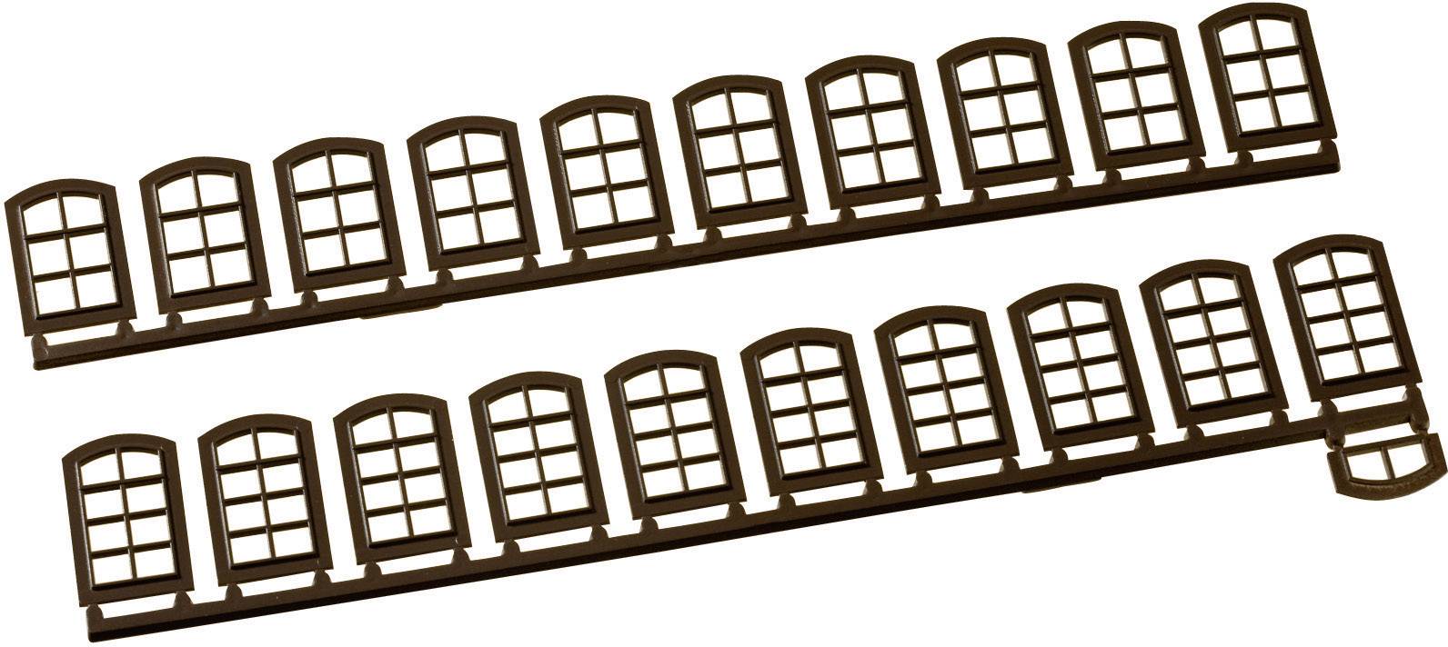 Plastic garden fence with decorative window-pattern design, suitable for bordering flower beds in a garden.