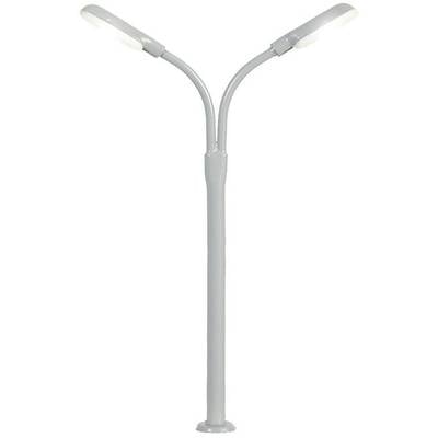 Grey two-headed street lamp with curved arms extending outwards. Stands on a circular base.