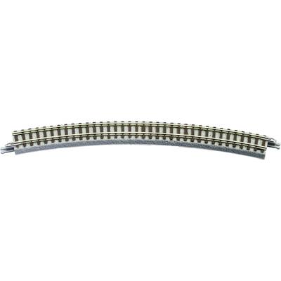 A curved model railway track with a ballast bed, showing a gentle curve; it is narrow and brown with metal struts.