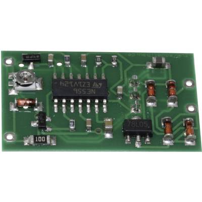Electronic circuit on a green circuit board with multiple electronic components, including microchip, capacitors and resistors.