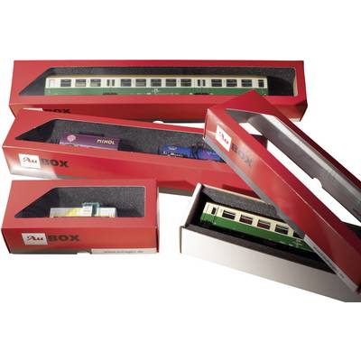 Toy train models in red packaging. Various wagons can be seen, including a green passenger carriage and a Minol tanker wagon.